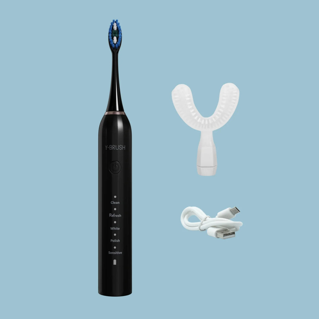 view of a Y-Brush DuoBrush electric sonic toothbrush on a blue background