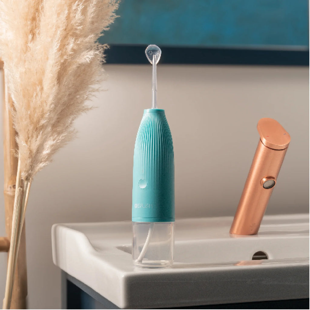 View of a Hydro-Go Water Flosser with tongue scraper attachement in a bathroom