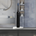 Black electric toothbrush on a stand with a blurred bathroom background